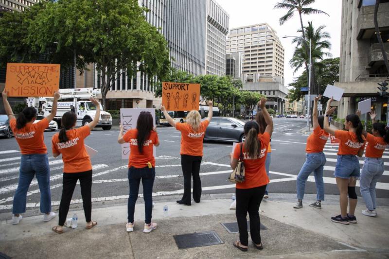 YMCA representatives waving signs at the 2023 AUW downtown rally